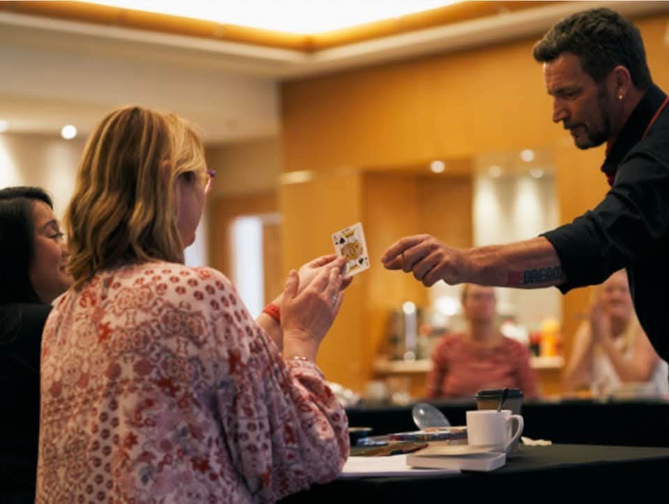 Michael Bennett performing close-up card magic for an audience
